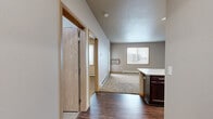 Located at 4740 Timber Pkwy S in Fargo, ND, this one-bedroom, one-bathroom unit offers a functional and well-appointed single-floor layout. The open-concept kitchen features rich dark cabinetry, stainless steel appliances including a refrigerator, range, and microwave, and a generous white countertop peninsula that doubles as a breakfast bar. Wood-style flooring runs through the kitchen and entry areas, adding warmth and easy maintenance underfoot.

The living area is carpeted and bathed in natural light through large windows with blinds, and includes a glass-panel door that opens to a private balcony. A wall-mounted HVAC unit and baseboard heating ensure year-round comfort. Neutral-toned walls throughout give the space a clean, move-in-ready feel.

The bedroom is a comfortable size, carpeted, and features a large window for natural light along with baseboard heating. It includes access to a dedicated walk-in closet outfitted with wire shelving and hanging rods, providing ample storage. The full bathroom is finished with a full tub/shower combo and tile-style flooring. A separate in-unit laundry area houses a full-sized washer and dryer, adding significant everyday convenience to this practical and well-organized home.