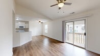 Located in Farmington, MO, this well-designed 2-bedroom, 1-bathroom single-floor residence offers a practical and comfortable layout. The open-concept living, dining, and kitchen area serves as the heart of the home, featuring warm hardwood-style flooring throughout and ceiling fans that enhance air circulation and comfort. Sliding glass doors lead to a private balcony, filling the living space with natural light and providing outdoor access.

The kitchen is outfitted with white cabinetry, granite-style countertops, a peninsula with a double sink, and white appliances including a range, microwave, and refrigerator. The layout connects seamlessly to the dining and living areas, making it ideal for everyday living.

Both bedrooms continue the hardwood-style flooring and are served by ample closet space, including sliding-door closets with wire shelving. Windows with blinds allow for natural light and privacy. The full bathroom features a tub/shower combo, a vanity with a granite-style countertop, and wood-style flooring.

Additional conveniences include a dedicated laundry area with a Whirlpool washer, a utility room, and four closets throughout the unit, providing generous storage. The bright, neutral palette creates a clean and inviting atmosphere throughout.