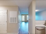 This 940-square-foot, single-floor condo in Myrtle Beach, SC offers a well-designed layout featuring 1 bedroom, 2 full bathrooms, 2 closets, and a private balcony. The open-concept kitchen and living area is anchored by a modern kitchen equipped with white shaker cabinetry, granite-style countertops with a breakfast bar, a tile backsplash, and stainless steel appliances including a refrigerator and range. The adjoining living room features warm wood-look laminate flooring and neutral walls, creating a bright, versatile space. The 160-square-foot bedroom is carpeted for comfort, features a ceiling fan with light, and is brightened by a window with blinds. Both bathrooms are finished with stone-look countertops, white cabinetry, wood-look flooring, and tub/shower combos. Two dedicated closets provide ample storage throughout the unit. The private balcony is a standout feature, offering picturesque views of a tranquil pond framed by mature trees and lush green lawns — ideal for relaxing outdoors. Neutral tones and consistent finishes throughout the unit create a cohesive, move-in ready aesthetic.