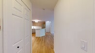 This 2-bedroom, 2-bathroom single-floor unit in Madison, WI offers a thoughtfully designed layout with a clean, modern aesthetic. The updated kitchen is a standout feature, showcasing light wood cabinetry, white quartz countertops, a peninsula breakfast bar, and a full suite of stainless steel appliances including a range, microwave, dishwasher, and refrigerator. Light hardwood flooring ties the kitchen and dining area together beautifully. The living room is carpeted and centers around a striking black-surround electric fireplace, with a sliding glass door that opens to a private balcony overlooking lush greenery. Both bedrooms are carpeted and generously sized, each equipped with ceiling fans and closets. The primary bedroom features a large window that brings in natural light and a view of the surrounding trees. The two bathrooms are tastefully updated, both featuring patterned tile flooring with a floral motif. One bathroom includes a modern light wood vanity with a white countertop and black hardware accents, while the other offers a full tub-shower combo. Baseboard heating is present throughout, and ceiling fans in multiple rooms add to year-round comfort. The overall ambiance is bright, clean, and move-in ready.