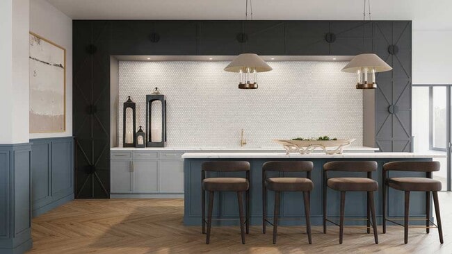 Stylish community bar area with blue cabinetry, quartz countertops, pendant lighting, and bar seating designed for social gatherings - Mesquite Trails at Brooks