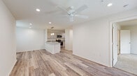 Located at 1200 Deana Rd in Ocean Springs, Mississippi, this single-floor unit offers a clean, contemporary design with a bright and open feel throughout. The main living area is spacious and airy, featuring light wood-style plank flooring, recessed lighting, and a ceiling fan that adds both style and function. Large windows allow natural light to fill the space, enhancing its open, welcoming ambiance.

The kitchen is a standout feature, designed with white shaker-style cabinetry, granite countertops, and a suite of stainless steel appliances including an electric range, over-the-range microwave, refrigerator, and dishwasher. A peninsula with a granite countertop and undermount sink serves as both a functional workspace and a casual dining area, accented by stylish pendant lighting overhead.

The bedroom is carpeted for comfort and includes a ceiling fan with a light fixture and a window offering an exterior view, creating a cozy and well-lit retreat. The bathrooms are finished in a clean, neutral palette, with one featuring a vanity with a white countertop and a mirrored cabinet, and the other offering a full bathtub and shower combination with wood-style flooring. The overall aesthetic throughout the unit is modern, minimalist, and move-in ready.