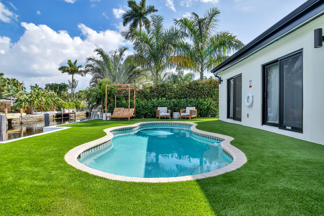 The outdoor pool area and dock. - 1005 Mango Is