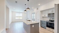 This well-designed 2-bedroom, 2-bathroom residence in Gainesville, Texas offers a thoughtfully planned single-level layout that maximizes functionality and comfort. The open-concept kitchen and living area serves as the heart of the home, featuring a central island with a granite countertop and undermount sink, stylish pendant lighting, and two-toned cabinetry with white upper cabinets and slate-blue lowers. A herringbone tile backsplash and stainless steel appliances, including a French door refrigerator and range with microwave, complete the contemporary kitchen. Light wood-look flooring flows throughout the main living areas, enhancing the bright, airy atmosphere created by recessed lighting and natural light from multiple windows. Both bedrooms are carpeted and include ceiling fans, with windows offering pleasant outdoor views. The primary bathroom features a glass-enclosed shower, a granite-topped vanity with blue cabinetry, and wood-look flooring. The second bathroom offers a tiled tub-shower combination, a granite vanity, and a large mirror. Two closets provide ample storage, and a hallway connects the rooms efficiently. The clean, neutral palette and modern finishes give the entire space a fresh, move-in-ready appeal.