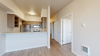Located at 256 Prince Ave in Bellingham, WA, this three-bedroom, one-bathroom unit offers a well-organized single-floor layout designed for efficient, comfortable living. The open-concept living area flows directly into the kitchen, which is equipped with stainless steel appliances including a refrigerator, electric range, and over-the-range microwave. Warm-toned wood cabinetry, light countertops, and a double-basin sink complete the functional kitchen space. Wood-look vinyl flooring runs consistently throughout the unit, lending a cohesive and easy-to-maintain aesthetic. The living room benefits from a large window and a private exterior door, allowing natural light to brighten the space and providing direct outdoor access. Each of the three bedrooms is modestly sized, featuring neutral walls, wood-look flooring, and closet storage — with the primary bedroom offering a built-in closet with a rod for hanging storage. The shared bathroom includes a full tub/shower combination with tile flooring and clean white fixtures. A hallway connects the main living areas to the bedrooms and bathroom, keeping the layout straightforward and practical. This unit offers a clean, modern finish suitable for everyday living in a residential Bellingham neighborhood.