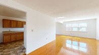 Located at 39 Latham Village Ln in Latham, NY, this single-floor, one-bedroom, one-bathroom home offers a well-organized and functional layout. The living room is a standout feature, presenting a generously sized, open area with beautifully polished hardwood floors that reflect natural light streaming in through large windows. The bright, white walls throughout the space contribute to a clean and airy atmosphere. A structural beam detail adds subtle architectural character to the living area.

The bedroom is a comfortable and well-proportioned room, also finished with the same gleaming hardwood floors. It includes two closet doors, offering ample storage, and benefits from natural light through a dedicated window.

The kitchen features warm honey-toned wood cabinetry paired with light countertops, providing practical storage and workspace. Stone-look tile flooring adds texture and distinction, setting it apart from the rest of the home. A floor vent ensures proper climate control in the space.

The bathroom is equipped with a full tub and shower combination, featuring a clean white surround with built-in shelving niches for convenience. A connecting hallway ties all rooms together, providing an efficient and logical flow throughout this well-maintained home.