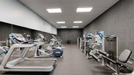 This 800-square-foot fitness center is a well-appointed, single-room facility designed to support a full range of workout routines. The space features a modern aesthetic with dark textured walls, light gray upper walls, and durable rubber flooring ideal for high-traffic gym use. Overhead, a drop ceiling with large recessed panel lighting ensures bright, even illumination throughout the room.

The cardio section is equipped with multiple treadmills, elliptical trainers, and a stationary recumbent bike, offering users a variety of aerobic exercise options. Strength training is well-represented with several cable and resistance machines positioned along the walls, complemented by a rack of dumbbells and kettlebells for free weight training. A dedicated abdominal and functional training machine rounds out the equipment selection.

Full-length mirrors line one wall, enhancing the sense of space while allowing users to monitor their form during exercise. Wall-mounted flat-screen televisions provide entertainment and add to the overall functionality of the space. Motivational signage, including a "Sweat, Mile, Repeat" display, contributes to an energetic atmosphere. The room is accessed through a single door and offers a clean, organized layout that maximizes the use of its 800 square feet.