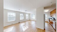 Located at 73 Washington St in New London, CT, this one-bedroom, one-bathroom unit offers a well-organized and functional layout across a single floor. The open living and kitchen area is a standout feature, characterized by gleaming light hardwood floors that reflect abundant natural light streaming in through multiple double-hung windows. The clean white walls and neutral palette create a bright, airy ambiance throughout.

The kitchen is thoughtfully appointed with warm honey-toned wood cabinetry extending from floor to ceiling, providing generous storage space. Dark speckled countertops offer ample prep area, and the kitchen includes a range with overhead ventilation, a double sink, and a peninsula that opens toward the living space — ideal for casual dining or entertaining.

The bedroom is a comfortable, carpeted retreat featuring a window that brings in natural light while maintaining privacy. Two closets provide practical storage throughout the unit.

The bathroom is clean and straightforward, featuring a full tub-shower combination with chrome fixtures and tile flooring. A connecting hallway links all areas of the unit efficiently. Overall, this unit offers a bright, well-maintained living environment with a cohesive, neutral design well-suited for comfortable everyday living.
