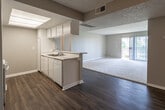 Located at 1754 W Arrow Rte in Upland, California, this single-floor residence offers a well-organized, open-concept layout designed for comfortable everyday living. The kitchen is equipped with white cabinetry extending to the ceiling for ample storage, light-toned countertops, a built-in dishwasher, and a gas range with overhead cabinetry. A breakfast bar peninsula separates the kitchen from the main living area, creating a seamless flow between spaces. The living area features a combination of durable wood-style flooring and plush carpeting, with large sliding glass doors fitted with vertical blinds that invite abundant natural light and provide access to an outdoor area. The bedrooms are carpeted and bright, each featuring windows with vertical blinds that frame views of surrounding greenery. The bathrooms are finished with white vanity cabinetry, integrated sink countertops, mirrored medicine cabinets with lighted fixtures, and enclosed tub and shower combinations with sliding glass doors, all set on wood-style flooring. Throughout the residence, textured ceilings and neutral wall tones create a clean, cohesive aesthetic. Central HVAC vents are present throughout, ensuring year-round climate comfort in this straightforward and functional Upland home.