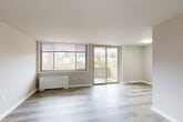Located at 7911 Indian Head Hwy in Oxon Hill, MD, this two-bedroom, one-bathroom residence offers a well-organized single-floor layout designed for comfortable everyday living. Light wood-look flooring flows seamlessly throughout, giving the space a clean and cohesive aesthetic.

The open combined living and dining area is a standout feature, bathed in natural light from large windows and sliding glass doors that lead to a private balcony with outdoor views. The balcony provides a pleasant retreat and extends the living space outdoors.

The galley-style kitchen is efficiently designed with light wood cabinetry, granite-look countertops, a stainless steel sink, gas range, and a full-size refrigerator — all oriented to maximize functionality within the compact layout.

Both bedrooms are well-proportioned, featuring large windows that invite natural light and outdoor views. The primary bedroom is generously sized and includes a double-door closet. The second bedroom also offers closet storage. Across the unit, an impressive five closets provide abundant storage throughout.

The full bathroom is finished in crisp white tones, featuring a vanity with mirror, a combination tub and shower, and marble-look tile flooring. The overall palette of soft grays and warm neutrals creates a calm and functional living environment.