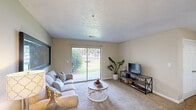 Located at 3800 Nicholasville Rd in Lexington, KY, this single-floor residence offers three bedrooms and one bathroom within a well-utilized, comfortable floor plan. The living room serves as the heart of the home, featuring plush carpet, a textured ceiling, and a large sliding glass door that fills the space with natural light and provides views of the outdoor greenery. A large wall mirror adds depth to the room, while the open sightline into the kitchen enhances the sense of connectivity throughout the space. The kitchen is bright and functional, featuring white cabinetry, white appliances, tile flooring, and a skylight that brings in additional natural light. A tall pantry cabinet provides ample storage, complementing the generous counter space. The primary bedroom is a comfortable retreat, complete with a ceiling fan and direct access to a closet with built-in wire shelving. The additional bedrooms offer carpeted flooring and neutral walls, suitable for a variety of uses including a home office. The bathroom features wood-look flooring, a tub-shower combination, a single vanity with storage, and a clean, straightforward design. Throughout the unit, warm beige tones and consistent finishes create a cohesive and welcoming ambiance.