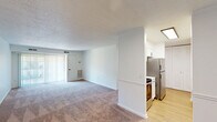Located at 3554 Weymouth St in Durham, NC, this single-floor, 2-bedroom, 2-bathroom residence offers a practical and comfortable layout. The open-plan living and dining area is generously sized, featuring neutral-toned carpet, a textured ceiling, and sliding glass doors that lead to a private balcony, filling the space with natural light. A half-wall partition separates the living area from the kitchen, which features light wood-style flooring, white cabinetry, and stainless steel appliances including a refrigerator and range. A utility room provides added convenience. Both bedrooms are carpeted with textured ceilings and window blinds that allow for natural light. The spacious primary bedroom includes a large closet with louvered bifold doors, while the second bedroom also benefits from a dedicated closet. The two bathrooms are clean and functional: one features a tub/shower combo with white tile surround and oil-rubbed bronze fixtures, while the other offers a white vanity with a vessel sink, a mirrored medicine cabinet, and matching matte black hardware. A hallway connects the rooms efficiently, and three closets throughout provide ample storage. The overall aesthetic is clean and neutral, offering a move-in ready canvas.