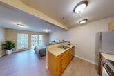 Located at 315 1st Ave W in Seattle's Queen Anne neighborhood, this efficiently designed studio offers a thoughtfully organized single-floor layout that maximizes every square foot. Light-toned luxury vinyl plank flooring runs throughout, lending a clean, cohesive look across all areas of the unit.

A welcoming hallway leads from the entry past two closets, providing generous storage. The open-plan living and sleeping area is bathed in natural light from a large sliding glass door that opens onto a private balcony, where elevated city views of the surrounding Seattle streetscape can be enjoyed. The living space is finished with warm neutral walls that complement the light flooring.

The kitchen features warm wood cabinetry with modern black hardware, light countertops, and a stainless steel sink, opening directly into the living area for an airy, connected feel. A dedicated laundry area adds everyday convenience within the unit itself.

The full bathroom is finished with a white vanity, light countertop, and a shower-tub combination enclosed by a stylish curtain, maintaining the unit's clean, neutral aesthetic. Flush-mount ceiling lighting throughout provides consistent, even illumination in every room.

This unit offers a practical and comfortable urban living experience in one of Seattle's most desirable neighborhoods.