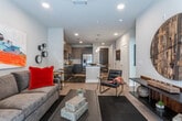 Located in Atlanta's vibrant Glenwood Park neighborhood, this single-floor residence offers a thoughtfully designed open-concept layout with contemporary finishes throughout. The kitchen is a standout feature, equipped with stainless steel appliances, two-tone cabinetry in taupe and dark gray, granite countertops, a subway tile backsplash, and a generous island with seating — ideal for both meal preparation and casual dining. Pendant lighting above the island adds a polished touch. Light wood-style flooring flows seamlessly into the living area, which is bathed in natural light from large windows and a glass door. A ceiling fan, recessed lighting, and an open wall create a comfortable and airy atmosphere. The bedroom features plush carpeting, large windows with blinds and draping curtains, and a ceiling fan, contributing to a calm and restful environment. The bathroom is finished with a granite-topped dark vanity, a large framed mirror, white subway tile surrounding the tub and shower, and coordinating tile flooring, offering a clean and modern aesthetic. Throughout the residence, neutral tones and contemporary design elements work together to create a cohesive, stylish living environment.