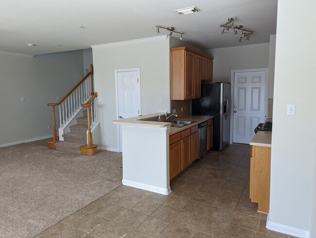 View of kitchen and living area from dining area - 1101 E Parmer Ln