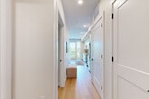 Located in Denver's desirable Park Hill neighborhood, this thoughtfully designed one-bedroom residence offers a clean, modern aesthetic across a single floor. Light hardwood flooring runs throughout the main living areas, complementing the bright, neutral color palette that gives the space an open and airy feel.

The entry hallway provides immediate access to two closets, offering ample storage from the moment you arrive. The kitchen is a standout feature, showcasing white flat-front cabinetry, white quartz countertops, stainless steel appliances, and an eye-catching herringbone tile backsplash with a subtle iridescent finish. The layout flows naturally into the living area, which is bathed in natural light from large windows and a glass balcony door. The balcony overlooks a lush, tree-filled streetscape, bringing a sense of calm and greenery into the space.

The bedroom is a serene retreat with recessed lighting, neutral warm-toned walls, and a double-door closet. The bathroom is finished with large-format tile on both the floor and tub surround, paired with a clean white vanity for a polished, cohesive look. Recessed lighting throughout the residence ensures consistent, modern illumination. This residence combines efficient use of space with high-quality finishes for comfortable urban living.