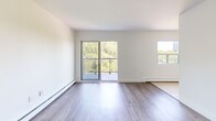 Located on the sixth floor at 530 Proudfoot Lane in London, Ontario, this 2-bedroom unit offers a comfortable and functional layout across a single floor. The open-concept living room is bright and airy, featuring light wood-tone laminate flooring, clean white walls, and large sliding glass doors that lead to a private balcony. The balcony provides sweeping views of the surrounding tree canopy and the broader neighbourhood, making it an inviting outdoor retreat. A second window in the living area further enhances natural light throughout the space.

The kitchen is efficiently designed with a galley-style layout, featuring white cabinetry, dark countertops, ceramic tile flooring, and stainless steel appliances including a refrigerator, stove, and built-in microwave. A breakfast bar connects the kitchen to the living area, adding a practical and social element to the floor plan.

Both bedrooms are finished with wood-tone laminate flooring and neutral-toned walls. The primary bedroom offers a generous footprint, while the second bedroom provides a comfortable and versatile space. Bedroom windows frame lush green tree views, creating a calm and natural ambiance. Baseboard heating is present throughout, ensuring year-round comfort in this well-maintained residential unit.
