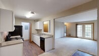 Located at 420 Munroe Falls Ave in Cuyahoga Falls, Ohio, this single-floor, three-bedroom, one-bathroom home offers a practical and comfortable layout designed for everyday living. The open-concept kitchen and living area form the heart of the home, where wood-look flooring in the kitchen transitions seamlessly into plush carpeting in the living space. The kitchen features white cabinetry, laminate countertops, a stainless steel sink, and a dishwasher, with a pass-through window that connects to the living area and enhances the sense of openness. The spacious living room receives natural light through a large sliding glass door, creating a bright and welcoming atmosphere. A central hallway connects the bedrooms and shared spaces. The generously sized primary bedroom offers ample room and is complemented by a walk-in closet equipped with wire shelving for organized storage. The additional bedrooms are carpeted with neutral tones, providing versatile spaces. The full bathroom includes a granite-style vanity countertop, a tub/shower combination, and tile flooring. A dedicated laundry area with washer hookups and built-in shelving adds everyday convenience. Textured ceilings and warm wood-tone trim are consistent throughout, lending a cohesive feel to the entire home.