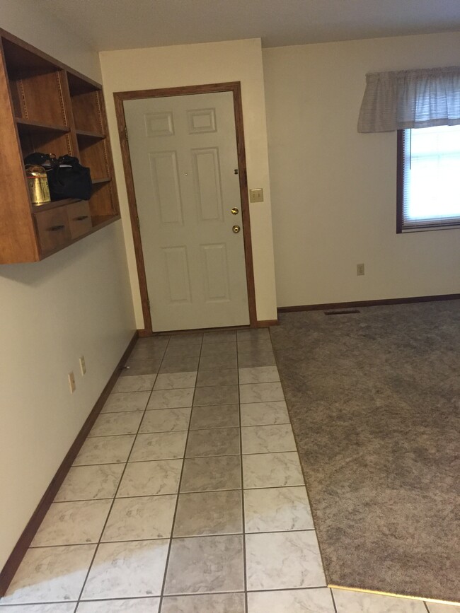 Front door with tile and carpet living room - 3716 Canal Blvd