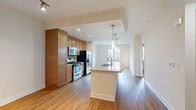 This 700 square foot apartment at The Residences At Bella Terra in Huntington Beach, CA, offers a thoughtful blend of comfort and style. The open-concept layout maximizes the use of space, creating a seamless flow between the living areas. The kitchen is a highlight, featuring modern stainless steel appliances, ample wooden cabinetry, and an elegant granite countertop that extends into a functional island.

The living area is bright and inviting, with large windows that allow natural light to flood the space. The bedroom, measuring 140 square feet, is carpeted for comfort and includes a spacious closet. The bathroom boasts a contemporary design with a granite vanity top, wooden cabinets, and a combination tub/shower with tiled surround.

Throughout the apartment, you'll find a mix of warm wooden floors and plush carpeting, creating a cozy yet sophisticated atmosphere. The neutral color palette provides a versatile canvas for personal decor. Recessed lighting and modern fixtures add to the overall ambiance. With its efficient design and quality finishes, this apartment offers a comfortable living space in a prime Huntington Beach location.