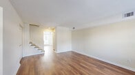 Located in Virginia Beach, VA, this two-story brick home offers 3 bedrooms, 3 bathrooms, and a well-designed layout spread across two floors. The main level features warm hardwood flooring throughout the living and dining areas, with large windows dressed in white blinds that invite abundant natural light and views of the surrounding neighborhood. The updated kitchen is outfitted with crisp white shaker cabinets, light countertops, stainless steel appliances including a refrigerator and dishwasher, and a window above the sink. A convenient half bathroom is also located on the main floor. Upstairs, the three bedrooms are carpeted for comfort, each offering closet space — including a spacious walk-in closet with built-in shelving in the primary bedroom. The upper level also includes two full bathrooms and a dedicated laundry area. With seven closets throughout, storage is plentiful. The exterior showcases classic brick construction, a concrete patio, and a backyard with scenic water views framed by mature trees — a standout feature of this Virginia Beach home.