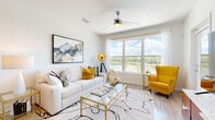 Located at 2130 Leather Fern Dr in Odessa, FL, this single-floor residence offers a thoughtfully designed open-concept layout with clean, contemporary finishes throughout. The living and dining areas are anchored by large windows that frame stunning water views, flooding the space with natural light and creating a bright, airy ambiance. A ceiling fan complements the well-lit interior, while wood-look flooring ties the common areas together seamlessly.

The modern kitchen is a standout feature, equipped with floor-to-ceiling flat-panel cabinetry in a warm taupe finish, stainless steel appliances including a range, microwave, dishwasher, and refrigerator, and a white quartz countertop island with bar seating — ideal for both meal prep and casual dining.

The bedroom is a serene retreat, carpeted for comfort and outfitted with a ceiling fan, natural window light, and access to a spacious walk-in closet with multi-tier wire shelving and hanging rods for generous storage. The bathroom is finished in a clean, minimalist style with a soaking tub, shower combo featuring marble-style tile surround, a floating vanity with white quartz countertop, and a large wall mirror. The overall design balances functionality with modern elegance throughout.