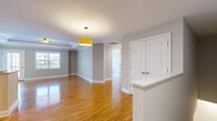 Located at 18 Stoneledge Dr in Troy, NY, this two-story, four-bedroom, two-bathroom home offers a well-organized and comfortable layout across two floors. The main level features a combined kitchen and living room area, where the kitchen stands out with rich cherry wood cabinetry, granite countertops, stainless steel appliances including a refrigerator, range, microwave, and dishwasher, and light tile flooring. The living area flows naturally from the kitchen and is highlighted by warm hardwood flooring and a tray ceiling with a ceiling fan, creating an open and inviting atmosphere with ample natural light. A full bathroom on this level features tile flooring, a granite-topped vanity, and a glass-enclosed shower. The staircase leads to the upper floor, where the majority of the living space resides. The generously sized primary bedroom is a standout feature, boasting a tray ceiling with a ceiling fan, multiple windows for natural light, and plush carpeting. Additional bedrooms on this floor are finished with soft carpeting, crown molding, and closet space. A carpeted hallway connects the upper rooms, and a second full bathroom with tile flooring and a granite vanity serves this level. The home's clean, neutral palette and consistent finishes throughout create a cohesive and move-in ready environment.