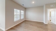 Located at 5001 Willowgate Loop in Fort Myers, Florida, this two-bedroom, two-bathroom two-story home offers a well-designed layout with a thoughtful blend of comfort and functionality. The main living level features an open-concept kitchen and living area with light wood-style flooring that carries throughout the main spaces. The kitchen is a standout feature, showcasing crisp white shaker cabinetry, a classic subway tile backsplash, granite-topped island with a double sink, and stainless steel appliances including a refrigerator, range, and built-in microwave. Recessed lighting brightens the space and adds a clean, modern feel. Both bedrooms are well-proportioned, with the primary bedroom offering multiple windows that invite natural light and views of the surrounding Florida landscape, plush carpeting, and direct access to a walk-in closet fitted with wire shelving systems. The second bedroom also features carpet flooring and a window with outdoor views. The bathrooms are finished with light wood-style flooring, granite-topped vanities, and built-in shelving. An attached garage with an automatic opener provides added convenience. A staircase connects the two levels, completing this practical and appealing Florida home.