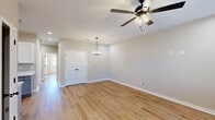 Located at 110 Peach Blossom Rd in Warner Robins, Georgia, this single-story, 3-bedroom, 2-bathroom home offers a clean, modern aesthetic with thoughtful finishes throughout. Warm-toned luxury vinyl plank flooring flows seamlessly across the entire living space, creating a cohesive and inviting atmosphere.

The living area is bright and open, featuring recessed lighting, a stylish ceiling fan with an integrated light fixture, and an elegant pendant chandelier that adds a refined touch. A set of arched double doors leads to a closet, adding classic architectural detail to the space. Natural light filters in through blinded windows, enhancing the home's airy feel.

The kitchen is well-equipped with white shaker cabinetry, light quartz countertops, an undermount sink with a matte black faucet, and a full suite of stainless steel appliances including a refrigerator, electric range, microwave, and dishwasher.

Each of the three bedrooms continues the consistent flooring and neutral color palette, with ceiling fans and windows that allow natural light to brighten the rooms. The spacious primary bedroom offers a comfortable retreat.

The bathrooms are clean and functional, featuring a tub-shower combination with matte black fixtures, a vanity with ample cabinetry, and light tile flooring. The home's cohesive design and modern finishes make it a move-in-ready option in Warner Robins.
