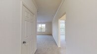 This well-designed apartment offers 1010 square feet of comfortable living space on a single floor. The layout includes two bedrooms, with the primary bedroom boasting a generous 190 square feet. Two full bathrooms provide convenience for residents and guests alike. The heart of the home is an open-concept kitchen and living room area, perfect for entertaining or relaxing. The kitchen features white cabinetry, a full suite of appliances, and ample counter space. Large windows in the living area and bedrooms flood the space with natural light, while plush carpeting adds warmth and comfort. A dedicated laundry room with full-size washer and dryer offers added convenience. The living room includes a cozy fireplace, adding both warmth and ambiance. Two closets provide ample storage space, while a hallway connects the various rooms. The bathrooms feature modern fixtures, including a shower/tub combination with a sleek design. Overall, this apartment combines functionality with comfort in a well-planned space.