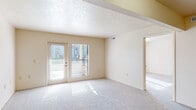 Located at 22424 Stillwater Ct in Elkhart, Indiana, this single-floor residence offers a well-organized layout with a variety of comfortable living spaces. The living area is generously sized, featuring plush carpeting, a textured ceiling, and a set of French doors paired with a large window that invites abundant natural light and provides views of the surrounding neighborhood. The open feel of the space is enhanced by clean, neutral-toned walls throughout.

The kitchen is equipped with ample cream-colored cabinetry, a gas range, a refrigerator, and a dishwasher, all set atop durable wood-look flooring that adds warmth to the functional layout. Multiple bedrooms offer carpeted floors and bright windows fitted with blinds, providing a quiet and comfortable environment.

The walk-in closet provides extensive wire shelving and hanging space, offering significant storage capacity. Two bathrooms serve the residence—one features a walk-in shower stall, a vanity with under-sink storage, and wood-look flooring, while the second includes a vanity, mirror, and accessibility grab bars. Together, these spaces form a practical and comfortable single-floor home in a residential Elkhart community.