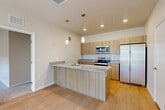 This 870 square foot single-story residence in Denver, Colorado, offers a compact yet functional living space with three bedrooms and two bathrooms. The home's modern design is evident throughout, featuring an open-concept layout that maximizes the use of space.

The property boasts large windows in several rooms, allowing ample natural light to flood the interior, creating a bright and airy atmosphere. The primary bedroom, measuring a generous 170 square feet, provides a comfortable retreat for homeowners.

The kitchen is a standout feature, showcasing contemporary design elements. It includes light wood cabinetry, sleek stainless steel appliances, and granite countertops. A central island with a breakfast bar adds both functionality and style to the space. The adjoining living area creates a seamless flow for entertaining.

Both bathrooms are thoughtfully designed with modern fixtures, including glass shower enclosures and granite-topped vanities. The use of light wood cabinetry in the bathrooms echoes the kitchen's aesthetic, maintaining a cohesive design throughout the home.

The flooring alternates between plush carpeting in the bedrooms and sleek hardwood in the main living areas and bathrooms, adding warmth and texture to the space. The neutral color palette throughout provides a blank canvas for personalization.

Despite its modest square footage, this home efficiently utilizes every inch of space, offering a comfortable and stylish living environment in the heart of Denver.