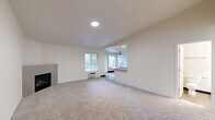 Located at 7531 NE 18th St in Vancouver, Washington, this two-bedroom, two-bathroom single-floor residence offers a thoughtfully designed layout ideal for comfortable everyday living. The spacious living room features plush carpeting, a corner fireplace with a tile surround, and large windows that fill the space with natural light. A pass-through opening connects the living area to the combined kitchen and dining room, which is outfitted with white cabinetry, stone-look countertops, stainless steel appliances including a full-size refrigerator, and wood-look flooring. A ceiling fan and additional window keep the kitchen and dining area bright and well-ventilated. The primary bedroom offers generous proportions with a double-door closet and carpeted flooring. The second bedroom mirrors the clean, neutral aesthetic with its own closet and carpet. Both bathrooms are finished with wood-look tile flooring, white vanity cabinetry, and stone-look countertops. Additional conveniences include a dedicated laundry room, multiple closets for ample storage, a hallway connecting all rooms efficiently, and a private balcony. The entrance provides a welcoming transition into the home's clean, neutral interior palette throughout.