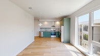 Located at 401 N 1st St in Rogers, Arkansas, this modern one-bedroom, one-bathroom unit offers a thoughtfully efficient layout with contemporary finishes throughout. Light hardwood flooring flows seamlessly across the entire space, creating a warm and cohesive aesthetic.

The open-concept kitchen and living area serves as the heart of the unit. The kitchen is a standout feature, outfitted with distinctive sage green cabinetry that extends floor to ceiling, providing generous storage. Granite-look countertops, a white subway tile backsplash, stainless steel appliances — including a dishwasher, electric range with overhead hood, and refrigerator — complete this well-appointed cooking space.

Large windows in the living area and bedroom invite abundant natural light, with views of the surrounding Rogers streetscape and neighboring architecture. The bedroom is a comfortable, well-proportioned retreat featuring a ceiling fan, a closet, and continued hardwood flooring.

The bathroom is clean and modern, incorporating granite-accented cabinetry with a sage green finish that echoes the kitchen design. A notable convenience is the in-unit stacked washer and dryer, located just off the bathroom. Throughout the unit, crisp white walls and recessed lighting reinforce the bright, contemporary character of this well-designed Rogers residence.