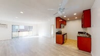 Located in the heart of Sherman Oaks, this single-floor unit at 4567 Willis Ave offers a well-designed, open-concept layout filled with natural light and contemporary finishes throughout. The spacious living area features light wood-style flooring, recessed lighting, a ceiling fan, and large sliding glass doors that open to a private balcony — bringing in abundant sunlight and a seamless indoor-outdoor connection. A wall-mounted AC unit ensures year-round comfort. The kitchen is thoughtfully appointed with rich wood cabinetry, dark granite countertops, tile flooring, and a full suite of stainless steel appliances, including a range, microwave, and dishwasher. The bedrooms are generously sized, each bathed in natural light via large windows, and continue the warm wood-style flooring found throughout the unit. A standout feature is the expansive walk-in closet, outfitted with wraparound shelving and hanging rods for ample storage. Two full bathrooms serve the space, both featuring granite-topped vanities with warm wood cabinetry. One bathroom includes a tiled shower-over-tub combination, while the second offers a glass-enclosed walk-in shower and tile flooring. Clean white walls and consistent finishes throughout create a bright, cohesive, and move-in-ready atmosphere.