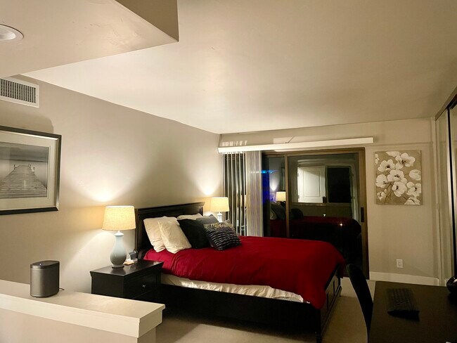 Large master bedroom with en suite bathroom, balcony access. - 500 N St