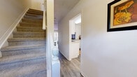 Located at 6403 Jamesville Dr in Tampa, FL, this single-floor home offers a thoughtfully designed layout with comfortable, interconnected living spaces. The open-concept living and dining area is anchored by wood-look laminate flooring, a textured ceiling, and large vertical-blind-covered sliding doors that draw in natural light. The living room provides ample space for seating arrangements and features multiple windows overlooking the surroundings, creating a bright and welcoming atmosphere.

The dining area flows seamlessly from the living room and sits adjacent to the kitchen, which is outfitted with white cabinetry, light countertops, a double-basin sink beneath a window, and white appliances including a range, microwave, dishwasher, and refrigerator. A breakfast bar with counter seating connects the kitchen to the main living area, making it ideal for casual dining.

The primary bedroom is generously sized with plush carpeting, a walk-in closet, and direct access to an en-suite bathroom featuring a walk-in shower. A second bedroom also offers carpet flooring and a standard closet with convenient hallway access. A second bathroom with a standalone shower stall serves the rest of the home. The overall ambiance is light, airy, and inviting throughout.