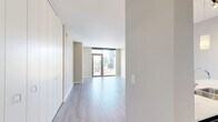 Located in Chicago's vibrant West Loop neighborhood, this one-bedroom, one-bathroom residence offers a thoughtfully designed layout with contemporary finishes throughout. Light gray hardwood-style flooring flows seamlessly across the open living space, anchored by expansive floor-to-ceiling windows and a glass balcony door that frames sweeping city skyline views and floods the interior with natural light.

The open-concept kitchen, dining, and living area serves as the heart of the home. The kitchen is outfitted with dark espresso cabinetry, stainless steel appliances including a gas range, microwave, and French door refrigerator, a light-colored glass tile backsplash, and a generous marble-veined quartz breakfast bar with pendant lighting overhead — ideal for both casual dining and entertaining.

The bedroom is a comfortable retreat, benefiting from its own access to the balcony and city views through large windows, complemented by an extensive built-in closet system. Four closets throughout the unit provide ample storage. The bathroom features large-format white tile flooring, dark vanity cabinetry with a white countertop, and a full soaking tub with dark gray tile surround. Neutral tones and clean lines throughout give the entire space a polished, modern character.