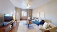 This well-designed apartment in Casa Bandera offers a comfortable 890 square feet of living space on a single floor. The layout comprises three bedrooms, including a primary bedroom of 120 square feet, two full bathrooms, a hallway, closet space, and a laundry room. The heart of the home is a combined dining and living area, perfect for both relaxation and entertaining.

The interior showcases a blend of modern and traditional elements. Hardwood flooring in the main living areas contrasts with plush carpeting in the bedrooms, while terra cotta tiles add character to the bathrooms and entryway. Neutral wall colors throughout provide a versatile backdrop for personalization.

Large windows in the bedrooms and living areas allow for ample natural light, with some featuring elegant curtains or blinds for privacy. The apartment boasts contemporary fixtures, including ceiling fans and recessed lighting. Thoughtful details such as a modern entertainment unit in the living room and practical storage solutions in the laundry area enhance the functionality of the space.

Artwork adorns the walls, adding pops of color and visual interest to the neutral palette. The overall ambiance is one of comfort and practicality, ideal for individuals or small families seeking a well-appointed living space in Las Cruces, New Mexico.