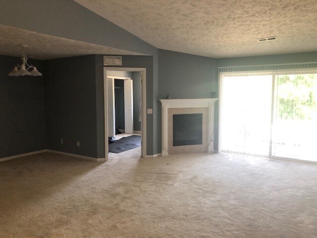 Living Room with fireplace and balcony - 911 Carom Cir