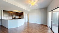 This well-appointed 2-bedroom, 2-bathroom residence at 15270 Ballast Point Drive in Fort Myers, Florida offers a thoughtfully designed single-floor layout. The open-concept living, dining, and kitchen area serves as the heart of the home, featuring warm hardwood-style flooring, a ceiling fan, and an airy feel enhanced by natural light. The kitchen is a standout, outfitted with rich dark cabinetry, granite countertops, a mosaic tile backsplash, stainless steel appliances including a refrigerator, range, microwave, and dishwasher, and a peninsula with a sink that opens to the living and dining space. Both bedrooms offer plush carpeting, ceiling fans, and ample natural light through slatted windows. The generously sized primary bedroom includes a dedicated closet and access to a dual-sink bathroom featuring granite countertops, dark cabinetry, and a glass-enclosed shower with hardwood-style flooring. Four closets throughout the unit provide abundant storage. Additional highlights include a private patio with outdoor views, an in-unit laundry area, and a practical utility panel. The neutral color palette and consistent finishes create a cohesive, move-in-ready environment throughout.