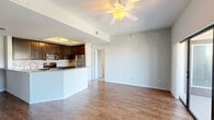 This well-appointed 2-bedroom, 2-bathroom residence at 15270 Ballast Point Drive in Fort Myers, Florida offers a thoughtfully designed single-floor layout. The open-concept living, dining, and kitchen area serves as the heart of the home, featuring warm hardwood-style flooring, a ceiling fan, and an airy feel enhanced by natural light. The kitchen is a standout, outfitted with rich dark cabinetry, granite countertops, a mosaic tile backsplash, stainless steel appliances including a refrigerator, range, microwave, and dishwasher, and a peninsula with a sink that opens to the living and dining space. Both bedrooms offer plush carpeting, ceiling fans, and ample natural light through slatted windows. The generously sized primary bedroom includes a dedicated closet and access to a dual-sink bathroom featuring granite countertops, dark cabinetry, and a glass-enclosed shower with hardwood-style flooring. Four closets throughout the unit provide abundant storage. Additional highlights include a private patio with outdoor views, an in-unit laundry area, and a practical utility panel. The neutral color palette and consistent finishes create a cohesive, move-in-ready environment throughout.