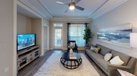 Located at 2309 Parklake Dr NE in Atlanta, Georgia, this single-floor residence offers a thoughtfully designed layout with a cohesive, modern aesthetic throughout. The living room is a standout space, featuring an elegant tray ceiling with crown molding, a ceiling fan, rich hardwood-style flooring, and large windows that invite abundant natural light. A private entry door adds convenience and connectivity to the outdoors.

The kitchen is well-equipped with white shaker cabinetry, a textured tile backsplash, stainless steel appliances including a range, microwave, refrigerator, and dishwasher, as well as a central island with white countertops — ideal for both cooking and casual dining. Light wood-tone flooring completes the clean, contemporary look.

The bedrooms are comfortably sized, each featuring plush carpeting, ceiling fans, and large windows with views of greenery outside. The rooms offer a calm, restful ambiance enhanced by neutral wall tones.

The bathrooms are finished with white vanity cabinetry, undermount sinks, large framed mirrors, and tub-shower combinations with tile surrounds featuring decorative accent borders. Wood-style flooring adds warmth to these well-lit spaces.

Overall, the residence presents a consistent, modern design language with neutral tones, quality finishes, and an emphasis on natural light and comfortable living.