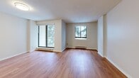 This spacious 840 square foot apartment in St. Catharines, Ontario offers a comfortable living environment with two bedrooms and two bathrooms. The unit is characterized by its abundance of natural light, courtesy of large windows that provide scenic views of the surrounding area. The living spaces are adorned with warm wood flooring, creating a welcoming atmosphere throughout.

The primary bedroom, measuring 150 square feet, offers ample space for relaxation. The kitchen is equipped with modern appliances, including a white electric stove, and features sleek white cabinetry complemented by neutral-toned countertops and a subway tile backsplash. Both bathrooms are designed for functionality, with one featuring a bathtub-shower combination and the other a walk-in shower, both equipped with safety grab bars.

The open-concept living and dining area is perfect for entertaining, with sliding glass doors leading to a balcony. The apartment also includes convenient features such as baseboard heating and a closet for additional storage. Located at 128 St Augustine Dr, this apartment combines comfort and practicality in a desirable location.