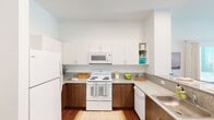 This single-floor residence showcases a cohesive modern design, unified by warm wood-tone flooring that flows throughout every room. The entry opens directly to the kitchen, which is efficiently laid out in a U-shape configuration. White upper cabinetry with clean-line hardware contrasts neatly with medium-toned wood lower cabinets, while granite-style countertops provide ample workspace. White appliances—including a refrigerator, electric range, over-the-range microwave, and dishwasher—complete the functional setup, alongside a stainless steel sink.

The living area is generously sized and filled with natural light from multiple windows fitted with horizontal blinds and drape panels. Elevated ceilings enhance the sense of openness, while a ceiling fan adds practical comfort. The bright, neutral walls create a versatile backdrop throughout.

The bedrooms are comfortably proportioned, each featuring windows that bring in natural light and views of surrounding greenery. The primary bedroom connects to a spacious walk-in closet with full-width wire shelving and hanging rods, offering substantial storage capacity.

The bathroom features a dual-sink vanity with wood cabinetry and granite-style countertops, a large mirror, and a tub-shower combination with floor-to-ceiling white tile surround, delivering a clean and functional finish.