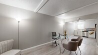 Located at 911 Pennsylvania Pl in Davis, CA, this single-floor unit offers a thoughtfully organized layout with a clean, modern aesthetic. Light gray walls, white baseboards, and light-toned wood-style flooring run consistently throughout, creating a cohesive and bright interior ambiance.

The space includes two office areas, each with textured ceilings featuring exposed beam detailing. One office is furnished with a glass-top desk setup and comfortable seating, while the other provides a more open, flexible configuration—both well-suited for productive work or adaptable use.

Two bedrooms are equipped with ceiling fans, mirrored sliding closet doors that amplify natural light, and windows with vertical blinds offering views of the surrounding greenery. Three closets throughout provide ample storage.

The kitchen is well-equipped with stainless steel appliances, including a refrigerator, electric range, microwave, and dishwasher, complemented by white cabinetry and a window above the sink that brings in natural light.

Two bathrooms serve the space: one features a double-sink vanity with a granite-style countertop, white cabinetry, and a large mirror with Hollywood-style lighting; the other includes a full bathtub and shower combo with tile surround in a diamond pattern. A connecting hallway links the rooms efficiently, completing this functional and stylish layout.