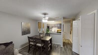 Located at 2534 Central Dr in Bedford, Texas, this single-floor residence offers a thoughtfully designed layout that balances comfort and functionality. The open-concept dining area flows seamlessly into the kitchen, connected via a convenient pass-through counter. The dining space features wood-look flooring, a ceiling fan with light fixture, and wall art that adds a contemporary touch. The kitchen is equipped with dark cabinetry, light quartz-style countertops, a subway tile backsplash, black appliances including an electric range and built-in microwave, and ample cabinet storage. The living room provides a welcoming atmosphere with wood-look flooring, a large sliding glass door that invites natural light, and generous wall space for artwork. The bedrooms are carpeted for comfort, each featuring ceiling fans, windows with blinds and curtains, and neutral wall tones that create a calm, restful environment. The bathroom includes a full tub-shower combination with a curved curtain rod, complemented by neutral gray tones throughout. The textured ceilings are consistent across the unit, adding a classic residential character. Overall, this residence presents a cohesive, neutral palette that offers a versatile and move-in-ready living space.
