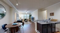 Located at 2525 W Tennessee St in Tallahassee, FL, this well-appointed 4-bedroom, 4-bathroom single-story unit offers a thoughtfully designed layout ideal for comfortable group living. The open-concept common area seamlessly connects the kitchen, dining, and living spaces under crown-molded ceilings with ceiling fans and track lighting. Wood-style flooring runs throughout, adding warmth and continuity across the space.

The kitchen features dark cabinetry, granite-style countertops, a double-basin sink, and stainless steel appliances, with a breakfast bar that opens to the dining and living areas. The living room is bright and welcoming, with multiple windows inviting natural light and a ceiling fan enhancing airflow.

Each of the four bedrooms is comfortably sized, with its own private bathroom — offering excellent privacy for all residents. The bedrooms include wood-style flooring, windows with blinds, and ceiling fans. The bathrooms are outfitted with dark vanity cabinetry and granite-style countertops consistent with the kitchen's design.

Additional highlights include seven closets for generous storage throughout, three hallways connecting the space efficiently, and a dedicated in-unit laundry room equipped with a full-size washer and dryer. This unit combines practical functionality with a clean, modern aesthetic.