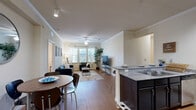 Located at 2525 W Tennessee St in Tallahassee, FL, this well-appointed 4-bedroom, 4-bathroom single-story unit offers a thoughtfully designed layout ideal for comfortable group living. The open-concept common area seamlessly connects the kitchen, dining, and living spaces under crown-molded ceilings with ceiling fans and track lighting. Wood-style flooring runs throughout, adding warmth and continuity across the space.

The kitchen features dark cabinetry, granite-style countertops, a double-basin sink, and stainless steel appliances, with a breakfast bar that opens to the dining and living areas. The living room is bright and welcoming, with multiple windows inviting natural light and a ceiling fan enhancing airflow.

Each of the four bedrooms is comfortably sized, with its own private bathroom — offering excellent privacy for all residents. The bedrooms include wood-style flooring, windows with blinds, and ceiling fans. The bathrooms are outfitted with dark vanity cabinetry and granite-style countertops consistent with the kitchen's design.

Additional highlights include seven closets for generous storage throughout, three hallways connecting the space efficiently, and a dedicated in-unit laundry room equipped with a full-size washer and dryer. This unit combines practical functionality with a clean, modern aesthetic.