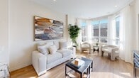 Located at 300 South Carriage Way in London, Ontario, this thoughtfully designed one-bedroom, one-bathroom unit offers a efficient and cohesive layout across a single floor. A welcoming entry hallway with light wood-tone flooring leads into the heart of the unit, where the kitchen and living area flow seamlessly together.

The kitchen is well-appointed with white shaker-style cabinetry, stainless steel appliances including a refrigerator, stove, and over-the-range microwave, and a marble-look quartz countertop that extends into a peninsula with bar seating. The open-concept living area is bathed in natural light from large windows, creating a bright and airy atmosphere with views of the surrounding neighbourhood. A glass door provides access to a private outdoor balcony area.

The bedroom is a calm, neutral space featuring a sliding-door closet, plush carpeting, and a window with sheer curtains that allow soft natural light to filter in. The full bathroom is clean and functional, finished with white tile surrounding a soaker tub and shower combination. A dedicated in-suite laundry area houses a stacked washer and dryer unit, adding practical convenience to the overall layout.